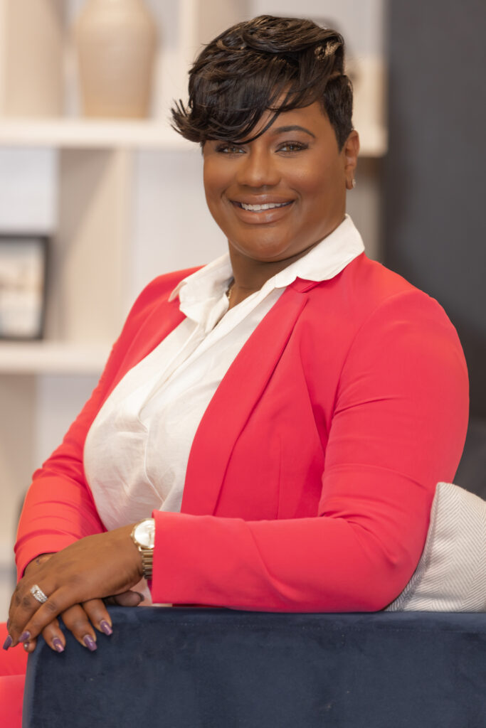 professional headshot of woman in pink suite 