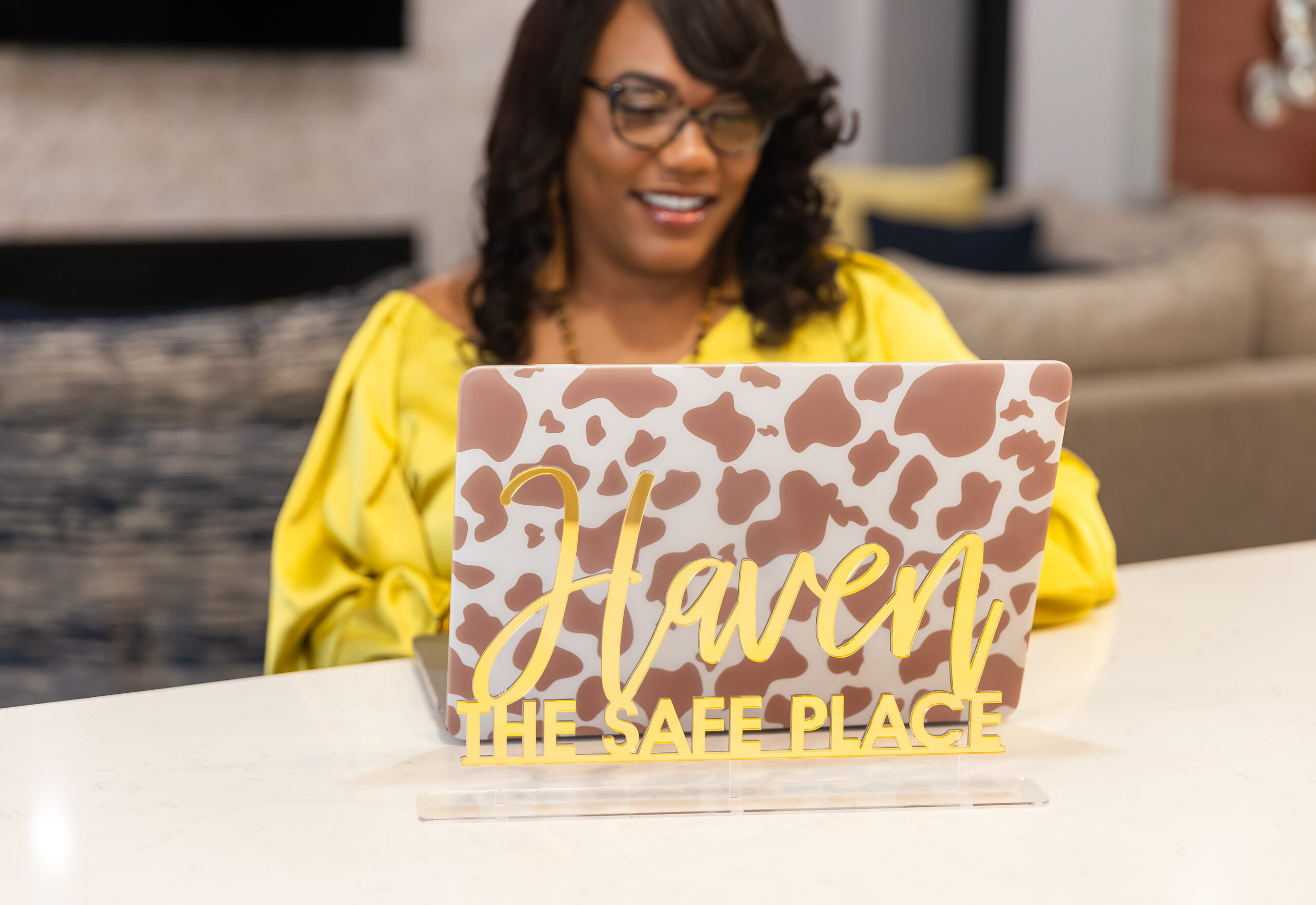 Woman working on a laptop while refining her brand strategy for improved brand presence